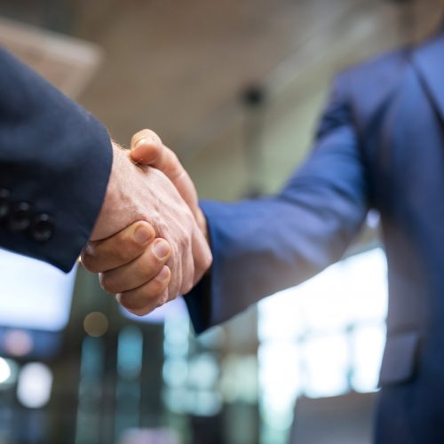 Agreement Deal Two Business people shaking hands after agree of proposal contract partners finishing up a meeting or setting goals and planning way to success in the office.Building a network towards success,handshake in contemporary office space